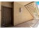 Apartment entrance featuring a sturdy door, outdoor lighting, and convenient stair access to upper units at 2134 E Broadway Rd # 1062, Tempe, AZ 85282