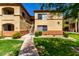 Well-maintained apartment building exterior with manicured lawn and inviting walkway on a sunny day at 2134 E Broadway Rd # 1062, Tempe, AZ 85282