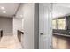 Bright hallway view leading to the living room with adjacent kitchen featuring tile floor and modern appliances at 2134 E Broadway Rd # 1062, Tempe, AZ 85282