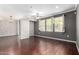 Spacious living room with hardwood floors, stylish lighting, and large windows providing ample natural light at 2134 E Broadway Rd # 1062, Tempe, AZ 85282