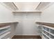 Walk-in closet with built-in shelving and rods for ample storage at 2134 E Broadway Rd # 1062, Tempe, AZ 85282