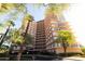 Elegant high-rise building featuring multiple balconies with access from each residence and lush, mature landscaping at 2201 N Central Ave # 3C, Phoenix, AZ 85004
