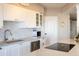 Clean kitchen featuring white cabinets, stainless steel appliances, and a center island cooktop at 2201 N Central Ave # 3C, Phoenix, AZ 85004
