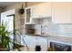 Close-up of a kitchen with white cabinets, stainless steel refrigerator, and stylish decor at 2201 N Central Ave # 3C, Phoenix, AZ 85004