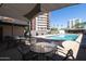 Inviting pool area offering shaded seating options with a high-rise building in the background at 2201 N Central Ave # 3C, Phoenix, AZ 85004