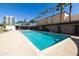 Inviting swimming pool with a lush palm tree landscape and high-rise building in the background at 2201 N Central Ave # 3C, Phoenix, AZ 85004