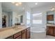 Elegant bathroom features double vanities, a tub, and natural light at 22709 S 202Nd St, Queen Creek, AZ 85142