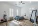 Bright bedroom featuring a ceiling fan, shuttered windows, and sleek flooring at 22709 S 202Nd St, Queen Creek, AZ 85142