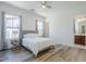 Bright bedroom featuring ensuite bathroom access and laminate wood-look flooring at 22709 S 202Nd St, Queen Creek, AZ 85142