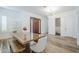 Bright dining area with wood floors, modern lighting and front door access at 22709 S 202Nd St, Queen Creek, AZ 85142