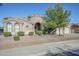 Inviting single-story home featuring desert landscaping, a circular turret entry, and an attached three-car garage at 22709 S 202Nd St, Queen Creek, AZ 85142