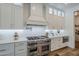 Chef's kitchen featuring stainless steel appliances, quartz counters, a subway tile backsplash, and shaker cabinets at 22709 S 202Nd St, Queen Creek, AZ 85142