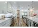 The bright, modern kitchen features stainless steel appliances, white countertops, and wood-style flooring at 22709 S 202Nd St, Queen Creek, AZ 85142