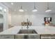 Close-up of the kitchen island featuring a stainless steel farmhouse sink and ample counter space at 22709 S 202Nd St, Queen Creek, AZ 85142