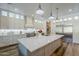 Stunning kitchen featuring a large island, stainless appliances, and elegant white cabinetry with glass accents at 22709 S 202Nd St, Queen Creek, AZ 85142