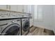 Well-lit laundry room with modern washer and dryer units at 22709 S 202Nd St, Queen Creek, AZ 85142