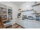 This well-organized pantry has white cabinetry, wood shelves, subway tile backsplash, and a variety of appliances at 22709 S 202Nd St, Queen Creek, AZ 85142
