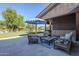Cozy outdoor seating area on the patio with comfortable chairs, accent rug, and a large shade umbrella at 22709 S 202Nd St, Queen Creek, AZ 85142