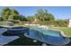 Inviting pool and spa with a waterfall feature, surrounded by lush landscaping with dining and lounging areas at 22709 S 202Nd St, Queen Creek, AZ 85142