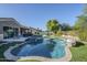 Inviting backyard pool with spa, featuring artificial turf, barbecue, patio and dining area at 22709 S 202Nd St, Queen Creek, AZ 85142
