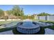 An inviting pool and spa with a waterfall feature, surrounded by lush landscaping and artificial grass at 22709 S 202Nd St, Queen Creek, AZ 85142