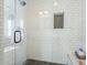 Shower with tiled walls, glass door, and a soap nook at 22709 S 202Nd St, Queen Creek, AZ 85142