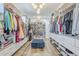 Spacious walk-in closet with custom shelving, cabinets, and lighting fixtures at 22709 S 202Nd St, Queen Creek, AZ 85142