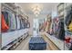 Large walk-in closet offering ample storage with an island ottoman at 22709 S 202Nd St, Queen Creek, AZ 85142