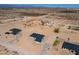 Aerial view of a single story home with dark gray roof and tan siding amid a desert landscape at 2689 S 305Th Ave Ave, Buckeye, AZ 85326