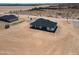 An aerial view of a new home and surrounding desert acreage with blue skies at 2689 S 305Th Ave Ave, Buckeye, AZ 85326