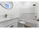 Bathroom with a tub and shower, marble countertop vanity, sleek hardware, and a modern mirror at 2689 S 305Th Ave Ave, Buckeye, AZ 85326