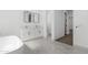 Modern bathroom with marble floors, double vanity, soaking tub, and neutral paint at 2689 S 305Th Ave Ave, Buckeye, AZ 85326