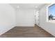 Light and airy bedroom features wood-look floors and a large window offering a pleasant view at 2689 S 305Th Ave Ave, Buckeye, AZ 85326