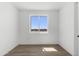 This bedroom features a large window with views and wood-look floors at 2689 S 305Th Ave Ave, Buckeye, AZ 85326