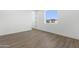 Well-lit bedroom features wood-look flooring and a large window with an outside view at 2689 S 305Th Ave Ave, Buckeye, AZ 85326