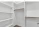 Spacious walk-in closet featuring custom shelving and wood trim at 2689 S 305Th Ave Ave, Buckeye, AZ 85326