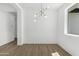 Well-lit dining room featuring wood floors and modern lighting fixtures at 2689 S 305Th Ave Ave, Buckeye, AZ 85326