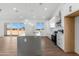 Gourmet kitchen features an island with a breakfast bar, white cabinets, stainless steel appliances and backyard views at 2689 S 305Th Ave Ave, Buckeye, AZ 85326