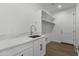 This laundry room features a white countertop and built-in shelving at 2689 S 305Th Ave Ave, Buckeye, AZ 85326