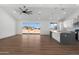 Spacious open floor plan with kitchen, living, and dining showcases views to the backyard through slider doors at 2689 S 305Th Ave Ave, Buckeye, AZ 85326