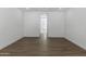 Spacious living room features white walls, recessed lighting, and beautiful wood-look flooring at 2689 S 305Th Ave Ave, Buckeye, AZ 85326