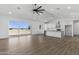 Large, open-concept space features kitchen, living, and dining with recessed lighting and a modern ceiling fan at 2689 S 305Th Ave Ave, Buckeye, AZ 85326