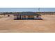 Single story house featuring a dark gray roof, tan siding and sliding glass doors to the backyard at 2689 S 305Th Ave Ave, Buckeye, AZ 85326