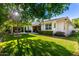 An expansive backyard features lush lawn, mature landscaping, and a covered patio for outdoor living at 2879 E Austin Dr, Gilbert, AZ 85296