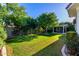 Expansive backyard with mature trees, a manicured lawn, and a covered patio for outdoor enjoyment at 2879 E Austin Dr, Gilbert, AZ 85296
