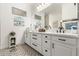 Stylish bathroom featuring double sinks, elegant tile flooring, and beach-themed decor at 2879 E Austin Dr, Gilbert, AZ 85296