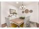 Elegant dining room featuring a large wooden table with seating for eight and stylish decor at 2879 E Austin Dr, Gilbert, AZ 85296