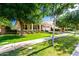 Beautiful single-story home with a well-kept lawn, inviting porch, and a charming tree-lined street at 2879 E Austin Dr, Gilbert, AZ 85296