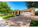 Beautiful single-story home featuring a manicured lawn and a brick-paved driveway at 2879 E Austin Dr, Gilbert, AZ 85296
