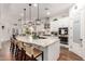 Well-lit kitchen showcasing a large island, modern pendant lighting, and ample cabinet space at 2879 E Austin Dr, Gilbert, AZ 85296